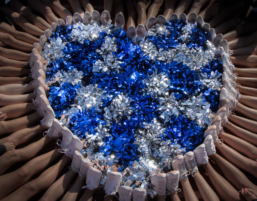 Blueand Silver Pom Poms Cheerleading Formation Wallpaper