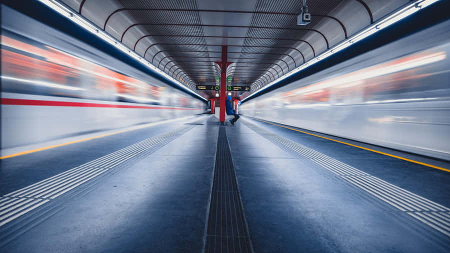 Blurred Train Passing Through Station.jpg Wallpaper