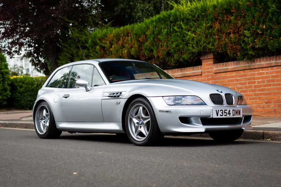 Bmw Z3 Roadster Cruising Down The Road Wallpaper