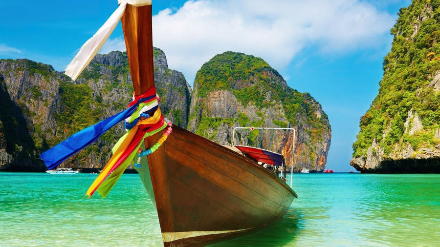 Boat Against Rocky Mountain Wallpaper