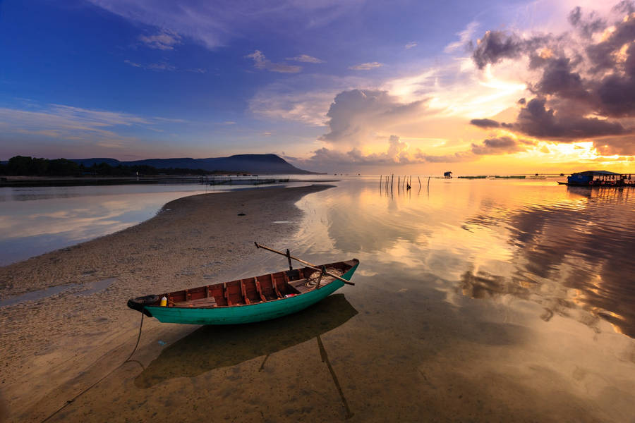 Boat On Sand Bar At Sunset Wallpaper