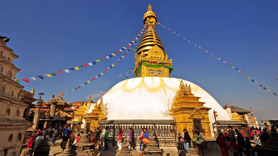 Boudhanath Stupa Under A Clear Sky Wallpaper