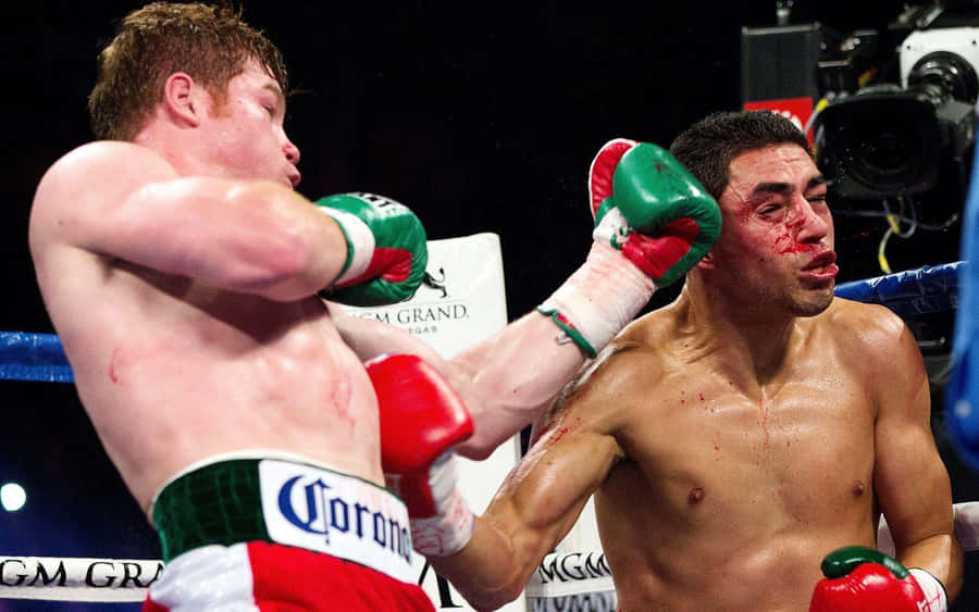 Boxing Star Saul ‘canelo’ Alvarez Delivering A Powerful Uppercut Wallpaper