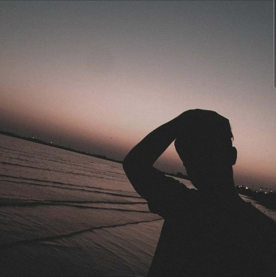 Boy Shadow Pfp On The Beach Wallpaper