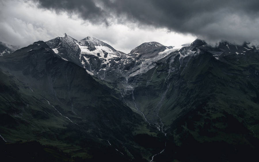 Brave The Elements With This Snow-capped Mountain Wallpaper