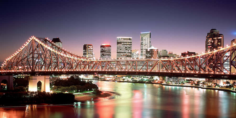 Breathtaking View Of Brisbane City Skyline At Sunset Wallpaper