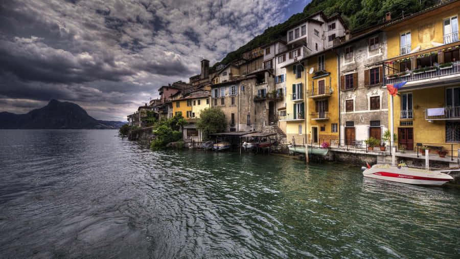 Breathtaking View Of Lugano Cityscape At Sunset Wallpaper