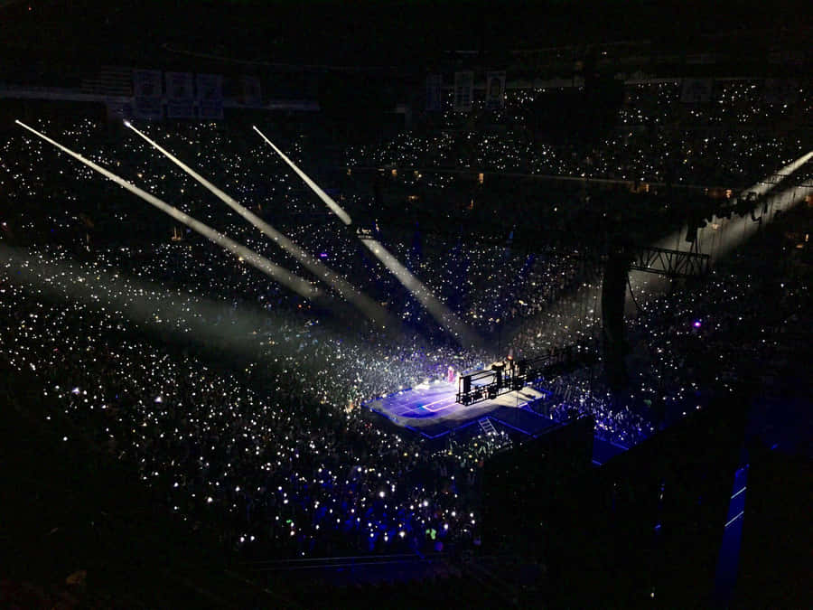 Bts Performing On Stage With Energetic Dance Routines And Powerful Vocals Wallpaper