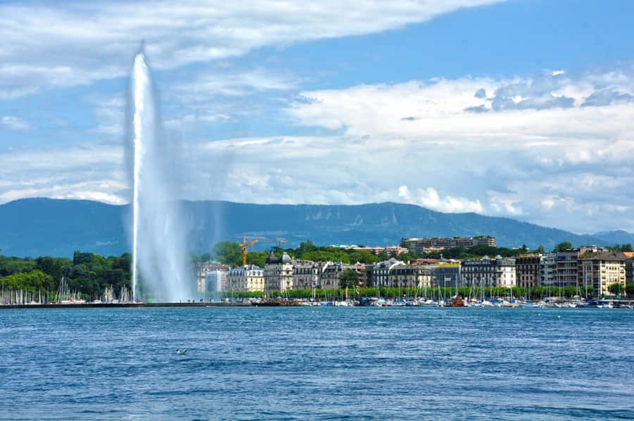 Caption: Breathtaking View Of Geneva Lake Surrounded By The Majestic Swiss Alps Wallpaper