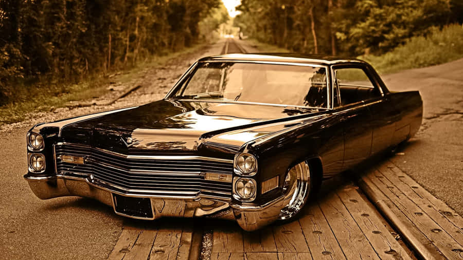 Caption: Classic Cadillac Deville In Its Natural Habitat Wallpaper