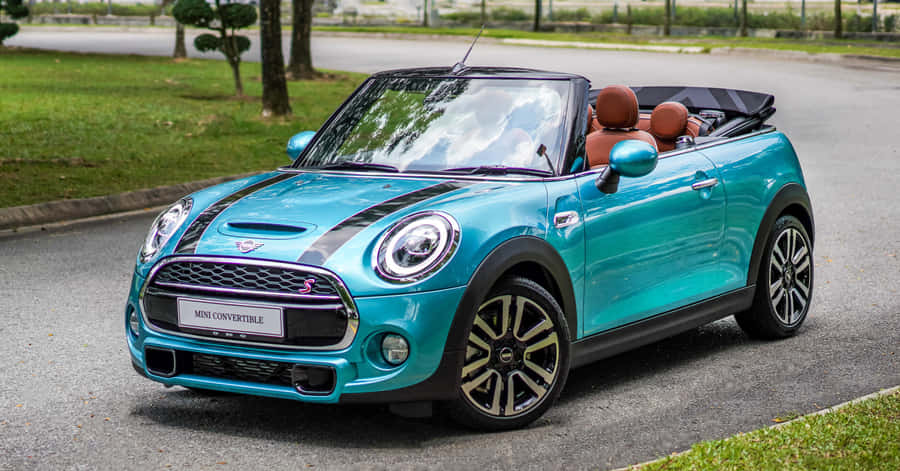 Caption: Elegant Mini Cooper Convertible Under A Dazzling Sky Wallpaper