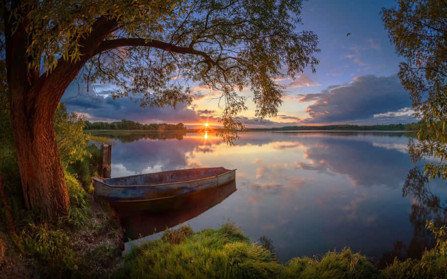 Caption: Exhilarating Boating Adventure In Serene Waters Wallpaper