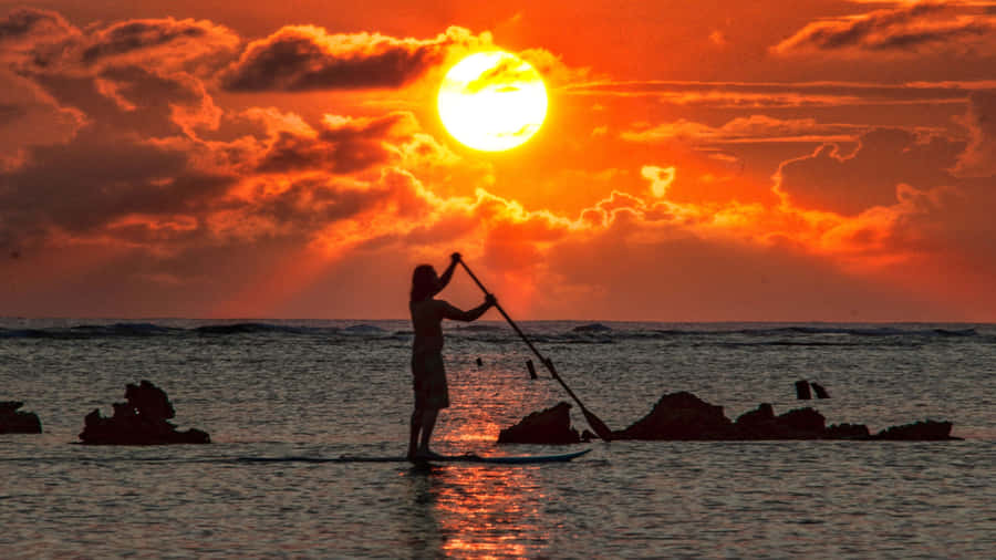 Caption: Exploring The Beauty Of The Ocean On A Paddleboard Wallpaper
