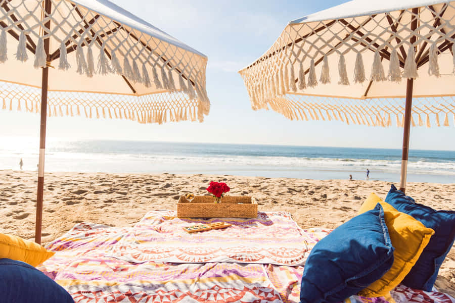 Caption: Friends Enjoying A Beach Picnic On A Sunny Day Wallpaper
