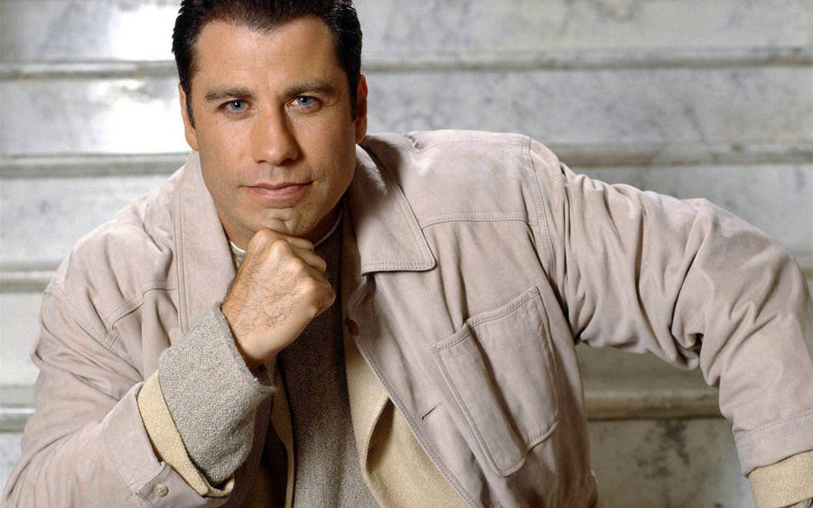 Caption: John Travolta: Iconic American Actor In Creative Pose Wallpaper