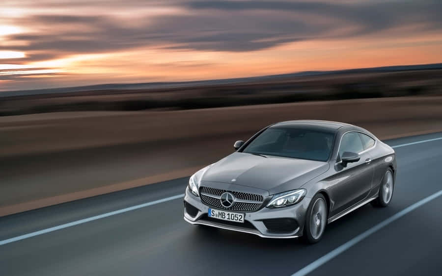 Caption: Luxurious Mercedes Benz C-class Amidst The Sunshine Wallpaper