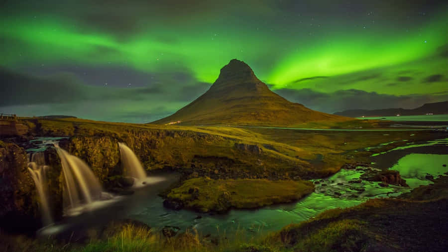 Caption: Majestic View Of Northern Lights In The Sky Wallpaper