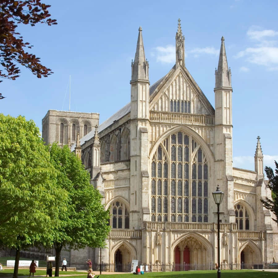 Caption: Majestic Winchester Cathedral Under The Blue Sky Wallpaper