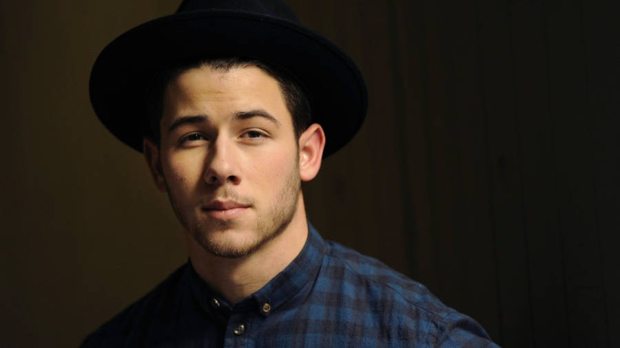 Caption: Nick Jonas Exudes Coolness In A Checkered Polo. Wallpaper