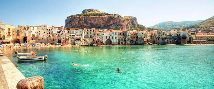 Caption: Picturesque Italian Island With Crystal Clear Waters Wallpaper
