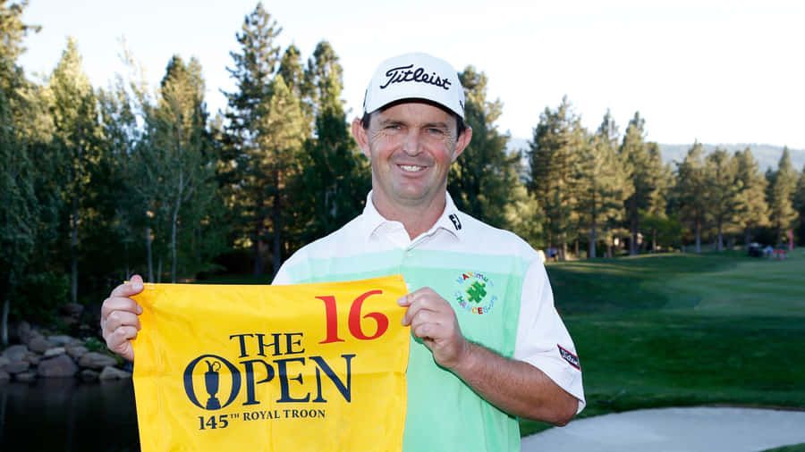 Caption: Professional Golfer Greg Chalmers Holding A Yellow Banner Wallpaper