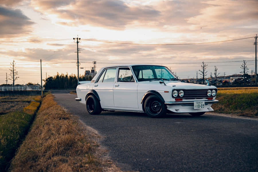 Caption: Retro Elegance - 1973 Datsun 510 Coupe Wallpaper