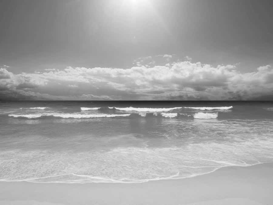 Caption: Serene Black And White Beach Scenery Wallpaper