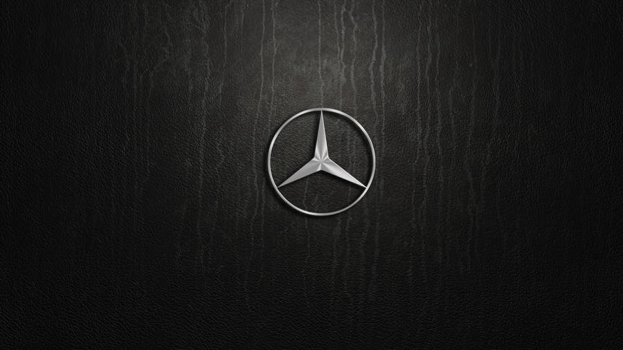 Caption: Silver Mercedes-benz Emblem Artistically Displayed Wallpaper