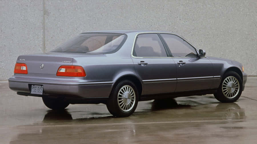 Caption: Sleek Acura Legend In Vibrant Cityscape Wallpaper