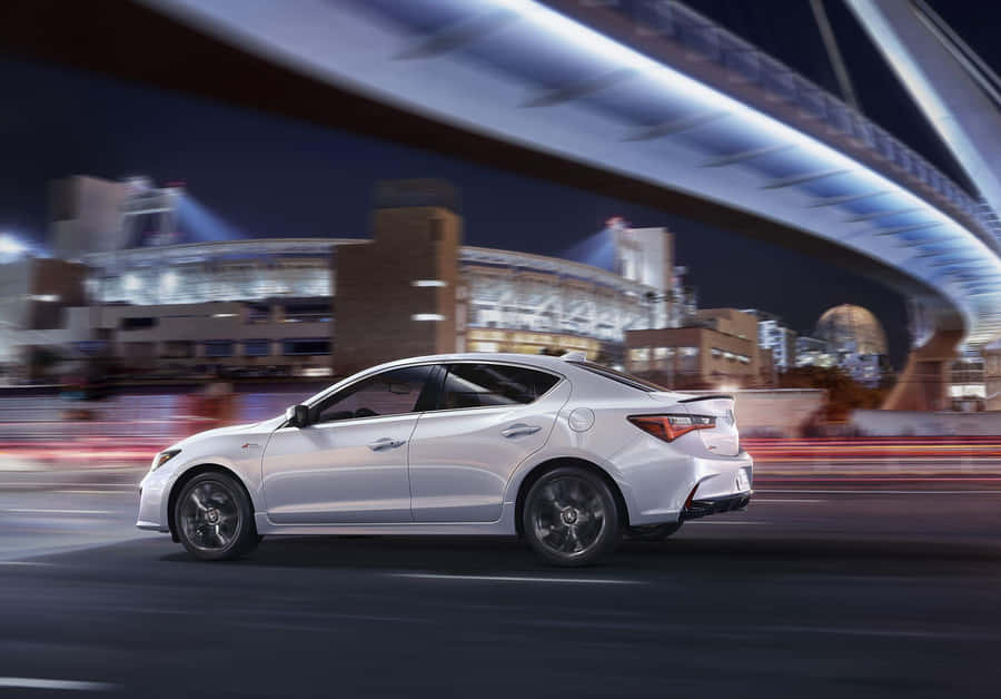 Caption: Sleek And Luxurious Acura Ilx Sedan In Action Wallpaper
