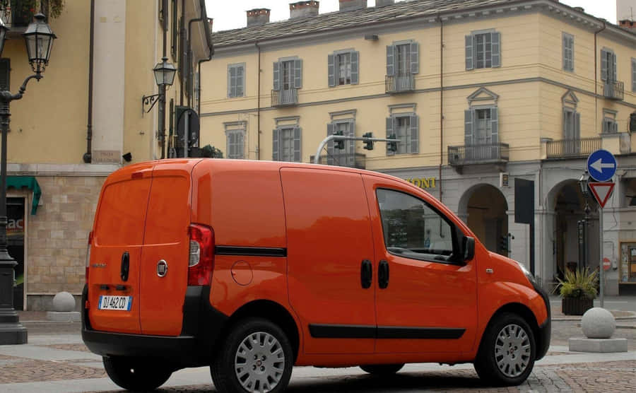 Caption: Sleek And Stylish Fiat Fiorino In Urban Setting Wallpaper