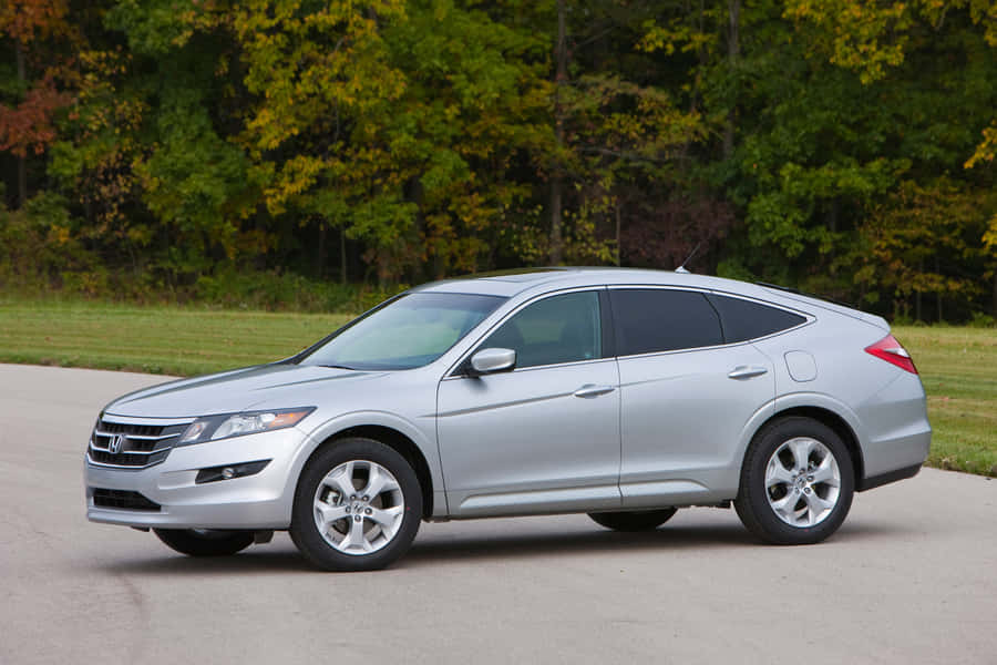 Caption: Sleek And Stylish Honda Crosstour In Natural Setting Wallpaper