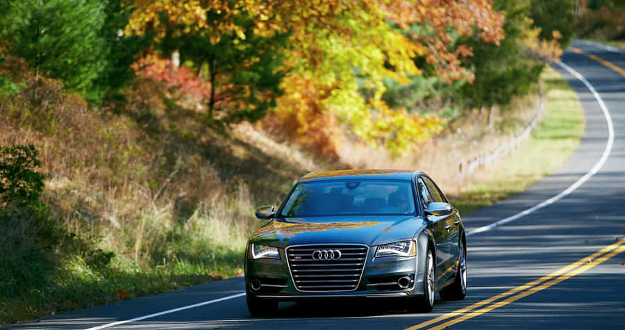 Caption: Sleek Audi S8 In A Striking Urban Setting Wallpaper