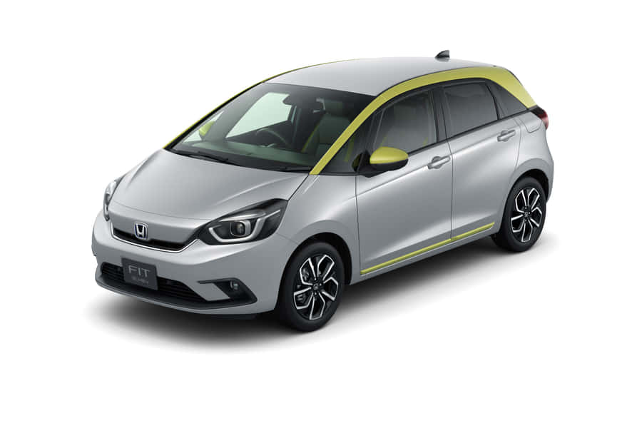 Caption: Sleek Honda Fit Driving On A Scenic Road Wallpaper