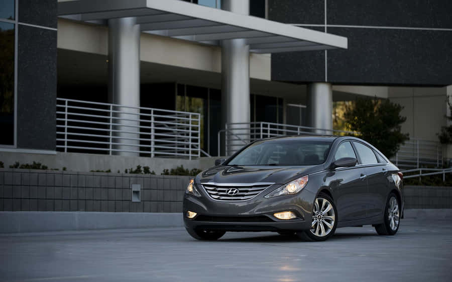 Caption: Sleek Hyundai Sonata Cruising On A Scenic Road Wallpaper