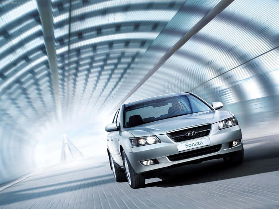 Caption: Sleek Hyundai Sonata In A Dynamic Urban Environment Wallpaper