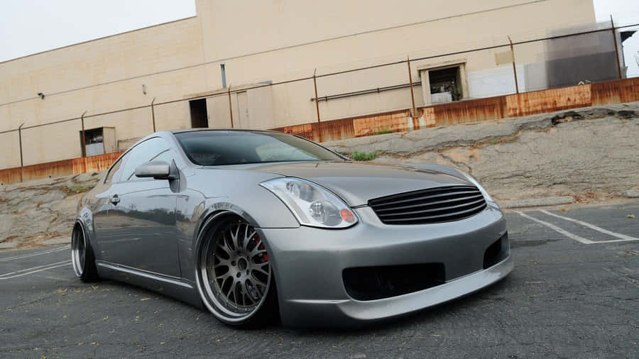 Caption: Sleek Infiniti G35 Cruising On Open Road Wallpaper