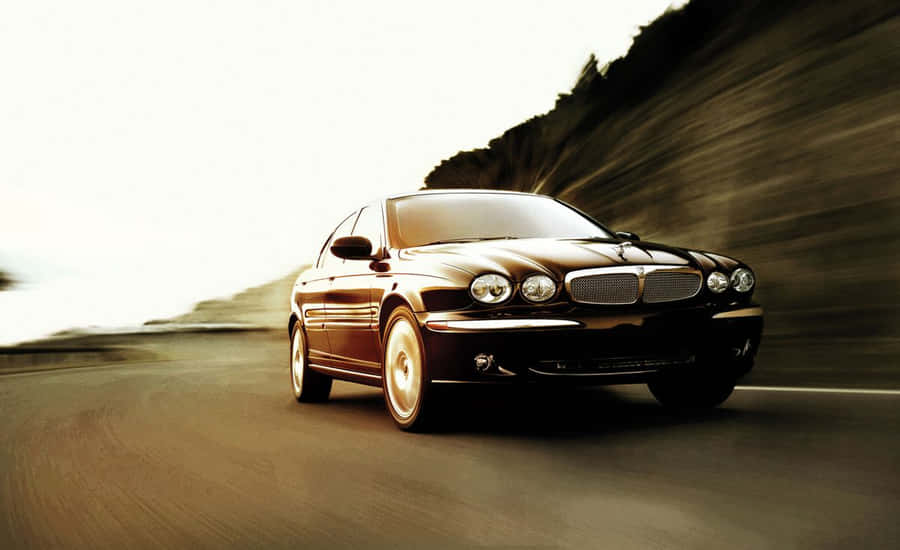 Caption: Sleek Jaguar X-type On The City Streets Wallpaper