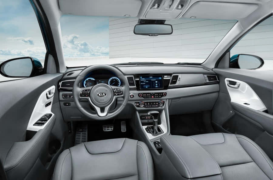 Caption: Sleek Kia Niro On A Scenic Road Wallpaper
