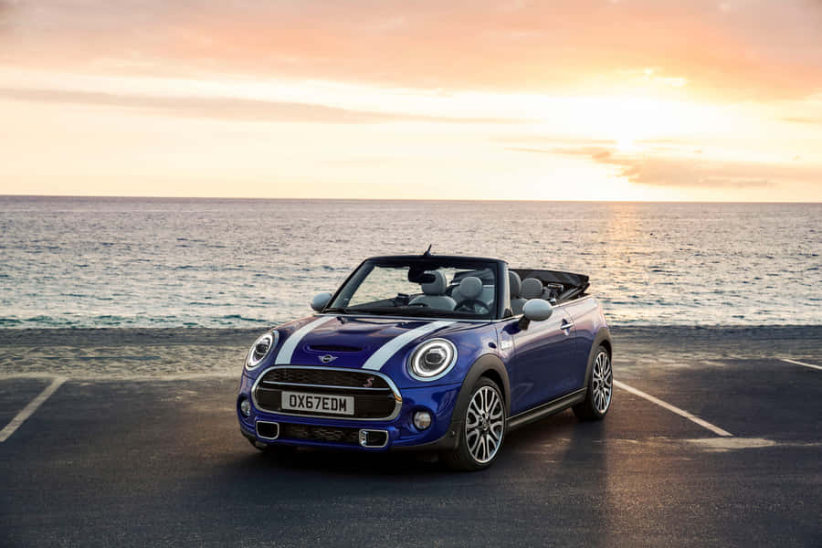 Caption: Sleek Mini Cooper Convertible Cruising On Open Road Wallpaper