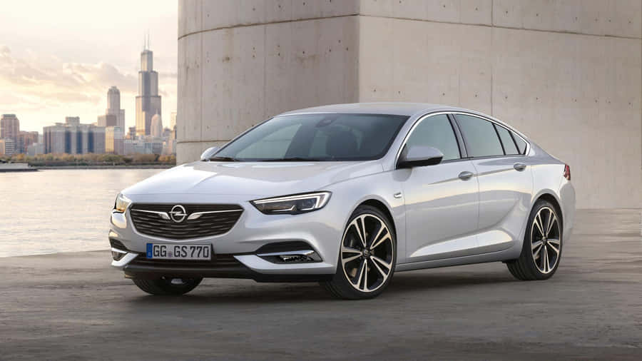 Caption: Sleek Opel Insignia Driving On A Scenic Route. Wallpaper