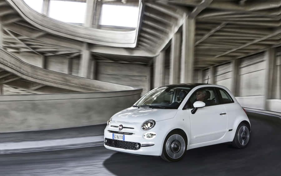 Caption: Sophisticated Fiat 500x Against Urban Landscape Wallpaper