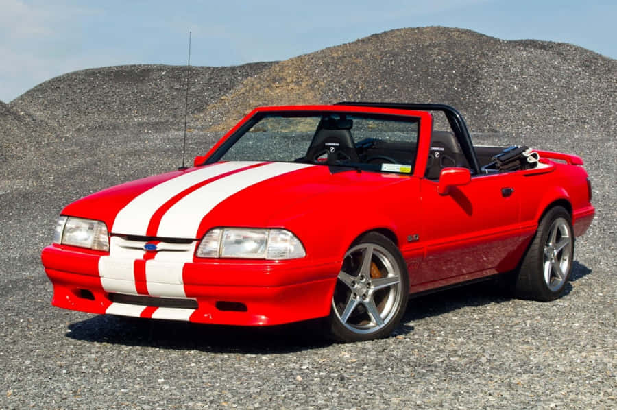 Caption: Striking Ford Mustang Gt Convertible Cruising On The Highway Wallpaper