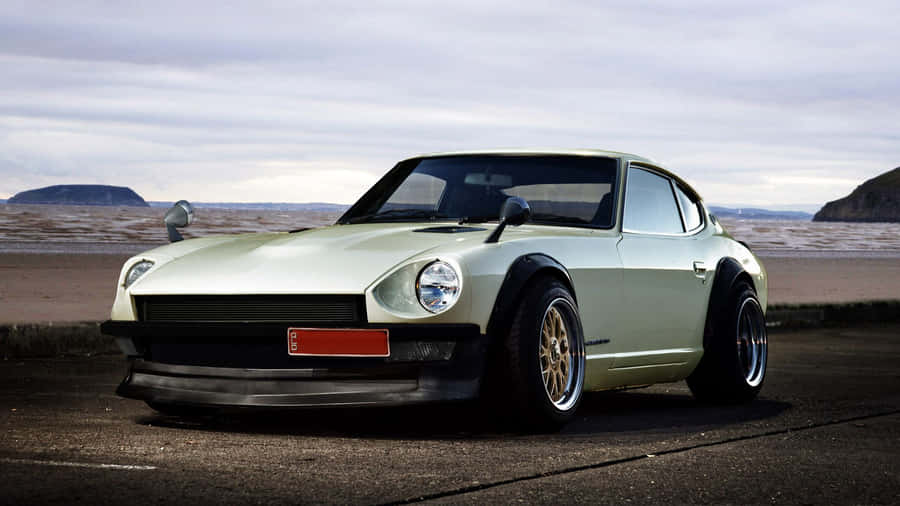 Caption: Stunning Datsun Classic Car On Road Wallpaper