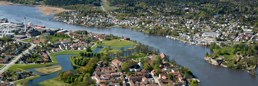 Caption: Stunning Sunrise Over Fredrikstad Old Town Wallpaper