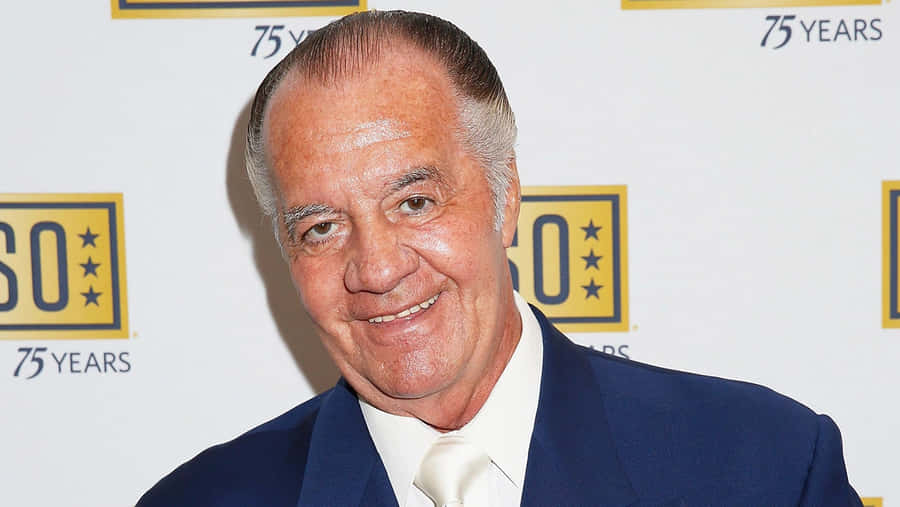 Caption: Tony Sirico Striking A Pose In A Suit Wallpaper