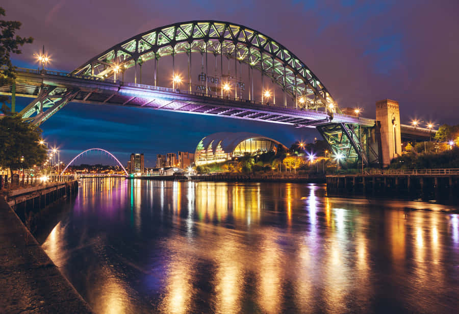 Caption: Vibrant Sunset Over Iconic Tyne Bridge, Newcastle Upon Tyne Wallpaper