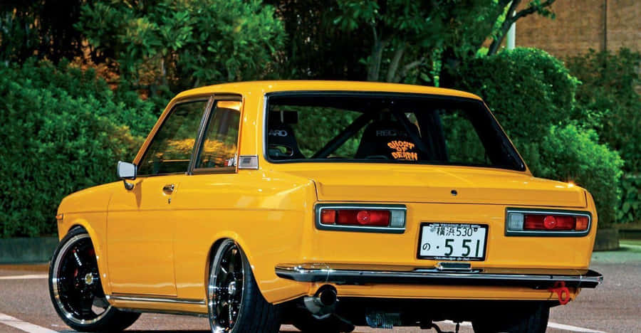 Caption: Vintage Datsun 510 Showcasing Its Classic Beauty Wallpaper