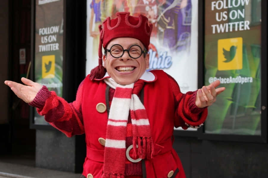 Caption: Warwick Davis Posing For A Photoshoot Wallpaper