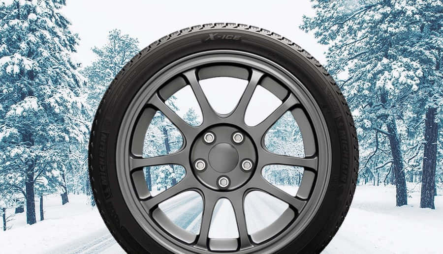 Caption: Winter Tires On A Snowy Road Wallpaper
